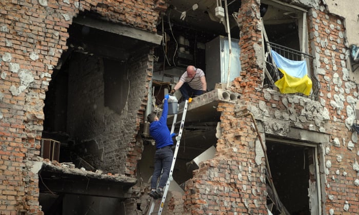 Irpin residents remove belongings from their house ruined by Russian shelling.