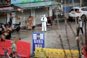 A worker in a protective suit is seen at the closed seafood market in Wuhan, Hubei province, China 10 January 2020.