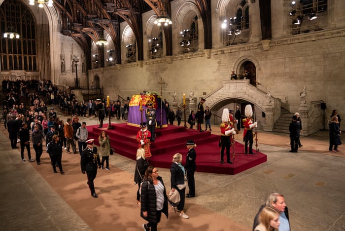Members of the public file past Queen Elizabeth II’s casket at midnight in Westminster Hall.