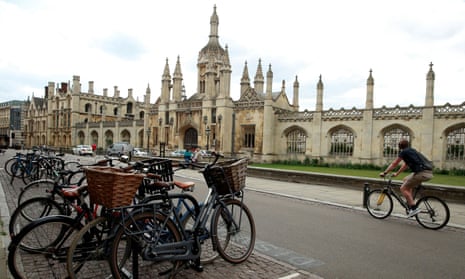 Cyclists are seen in front of Cambridge University, following the outbreak of the coronavirus disease