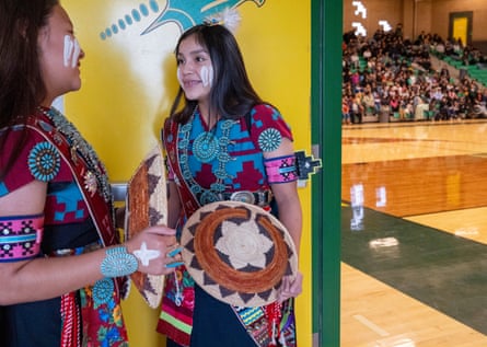 Two women in traditional dress talking to each other
