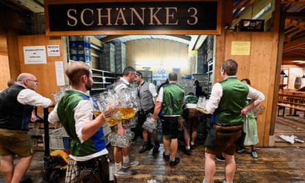 Waiters picking up beer steins at the end of the Oktoberfest, in Munich, Germany, October 3, 2023.