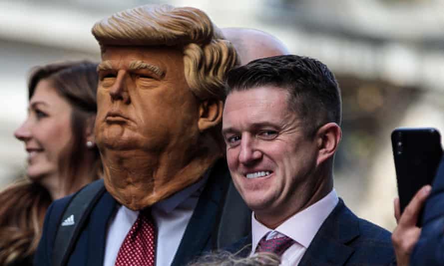 Stephen Yaxley-Lennon stands beside a man in a Donald Trump mask as he addresses supporters outside the Old Bailey in London, England.