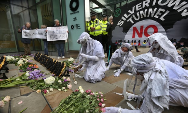 Anti-pollution protesters lay flowers outside the offices of the Silvertown tunnel contractor, Macquarie, in London in October last year