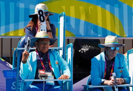 Diving judges using manual cards to score competitors in the Gold Coast Commonwealth Games.