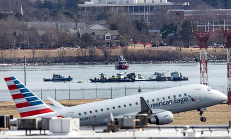An American Eagle flight takes off from Ronald Reagan Washington National Airport in front of the wreckage of a commercial airplane that collided with a military helicopter, in Arlington, Virginia, USA, 30 January 2025. An American Eagle flight takes off from Ronald Reagan Washington National Airport in front of the wreckage of a commercial airplane that collided with a military helicopter, in Arlington, Virginia, USA, 30 January 2025.