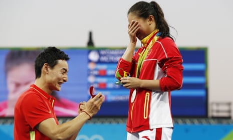 Silver medallist China’s He Zi (R), receives a marriage proposal from Olympic diver Qin Kai of China