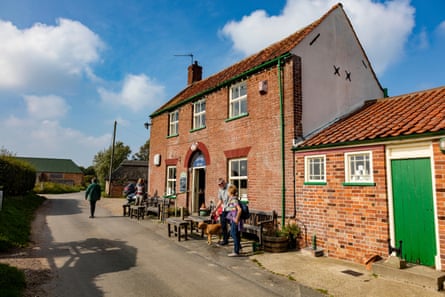People outside a pub on a sunny day