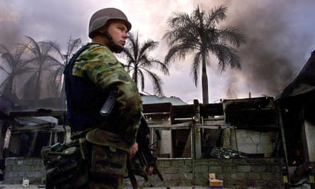 An Australian soldier keeps guard in a Dili street in late September 1999