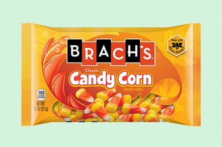 Orange bag of Brach’s candy corn against green background