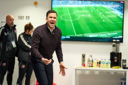Manager Gary Caldwell speaks to his players at half-time