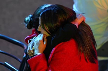 People hug after the preliminary results of Bolivia’s presidential runoff election are announced.
