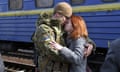 A couple embrace prior to the woman boarding a train carriage leaving for western Ukraine, at the railway station in Kramatorsk, eastern Ukraine, Sunday, Feb. 27, 2022. The U.N. refugee agency says nearly 120,000 people have so far fled Ukraine into neighboring countries in the wake of the Russian invasion. The number was going up fast as Ukrainians grabbed their belongings and rushed to escape from a deadly Russian onslaught. (AP Photo/Andriy Andriyenko)