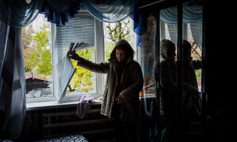 An elderly woman examines her damaged home following a shelling on the town of Bakhmut in Donetsk region, on 25 October.