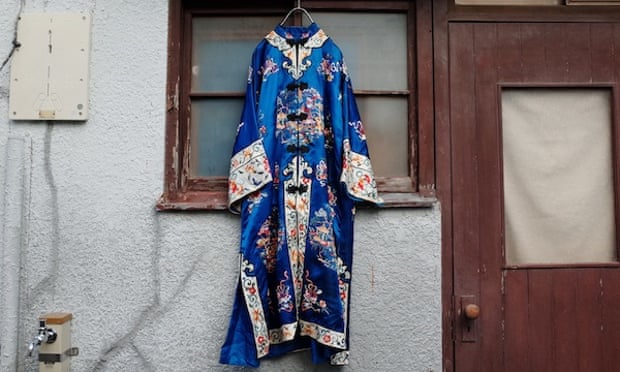 A blue and heavily patterned traditional Japanese outfit from Sokkyou hangs outside a house in the Koenji district of Tokyo, Japan.