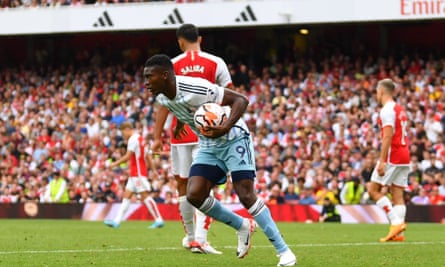 Taiwo Awoniyi holds the ball in his hands and heads to the centre-circle after pulling a goal back for Nottingham Forest at Arsenal.