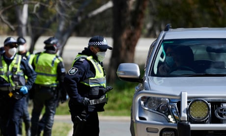 Masked NSW police officer speaks to driver of car