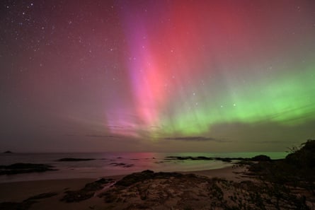 The southern lights glow over the waters of Brighton Beach in Dunedin.
