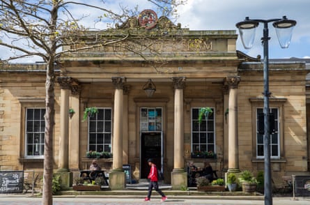 A neoclassical building with columns and the name Head of Steam in gold lettering above them