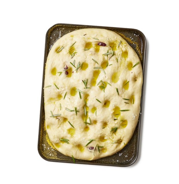 Make dimples in the dough, make and emulsion of oil and water, cover the dough in the emulsion, then scatter herbs and flaked salt on top.