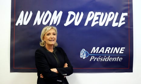 Marine Le Pen poses in front of a poster for her 2017 French presidential election campaign.