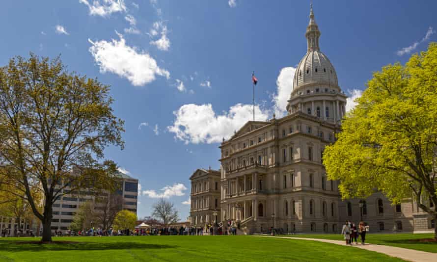 People attend a protest for voting rights at the Michigan state capitol in Lansing on 13 April.