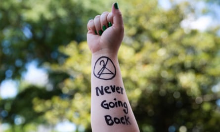 An activist holds up her arm during a protest against recently passed abortion ban bills at the Georgia State Capitol building.