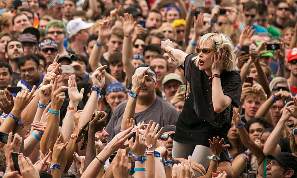 Packed crowd of people with arms in air