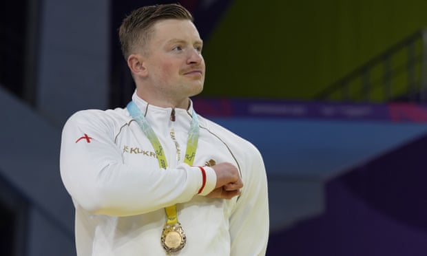 Gold medalist Adam Peaty of England stands to Jerusalem during the medal ceremony for the men's 50m breaststroke final at the Commonwealth Games.