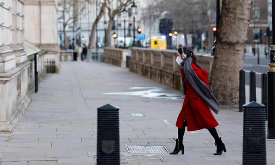 A woman walks along Whitehall in London