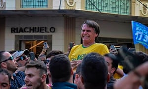The Brazilian rightwing presidential candidate Jair Bolsonaro gestures after being stabbed in the stomach during a campaign rally in Juiz de Fora, Minas Gerais.