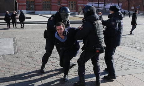 Russian police detain a man during a protest rally in front of the Kremlin, March,13,2022, in Moscow