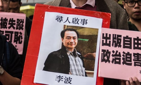 A protestor holds up a missing person notice for Lee Bo, one of five Hong Kong booksellers from the same Mighty Current publishing house to go missing at the hands of the Chinese.
