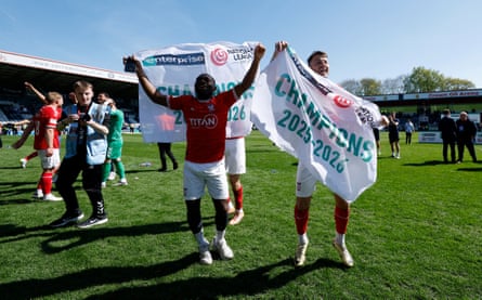 York City’s players celebrate on the pitch at the final whistle.