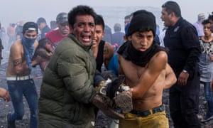 Severely burnt victims are taken away from the smoldering ruins of the fireworks market on Tuesday.