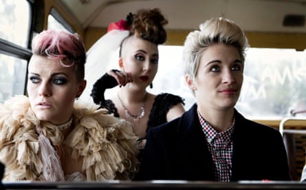 Three young women in the back of a bus