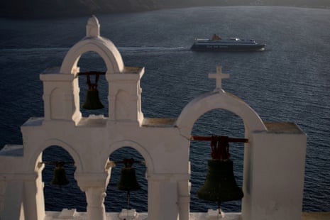 A ferry sails near the island of Santorini, Greece.
