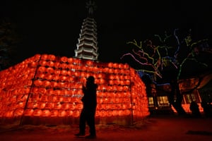 A Buddhist follower prays in front of lotus lanterns during celebrations for the New Year at Jogye temple in Seoul