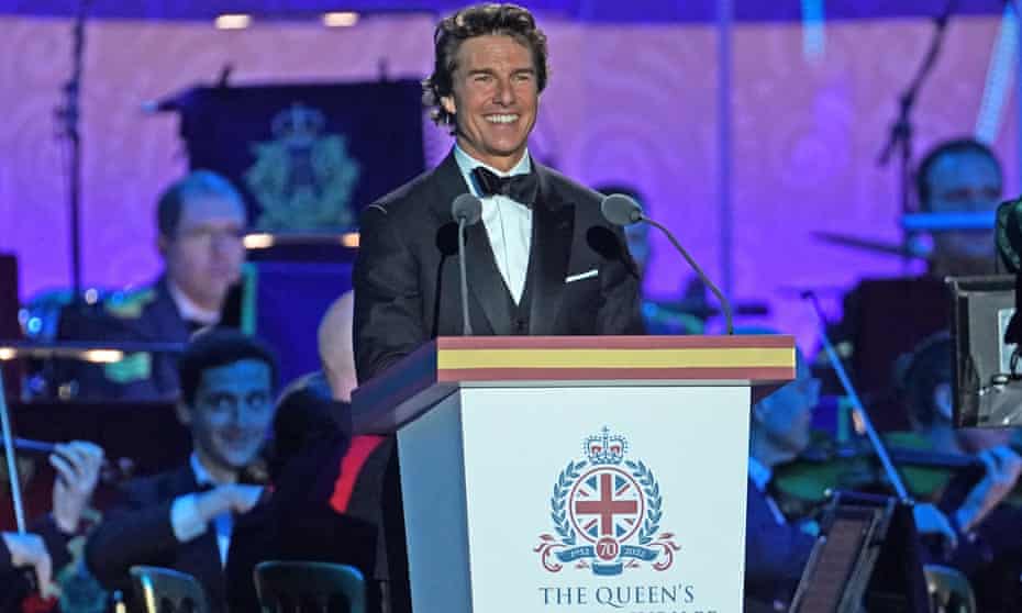 Tom Cruise beams a very white smile from the podium at The Queen’s Platinum Jubilee Celebration.