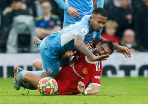 Manchester City’s Gabriel Jesus tussles with Manchester United’s Bruno Fernandes.