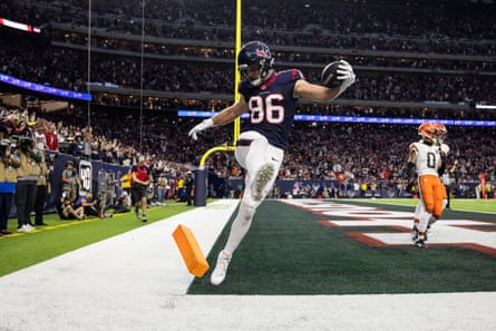 Dalton Schultz of the Houston Texans celebrates by kicking the pylon after catching a pass for a touchdown during Saturday’s AFC wildcard playoff game.