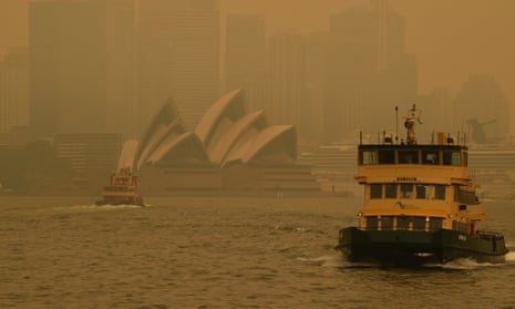 A ferry passes by the Sydney Opera House as smoke haze from bushfires blankets the city in 2019.