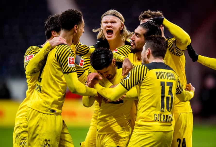 Mahmoud Dahoud is surrounded by his Borussia Dortmund teammates after his late winner