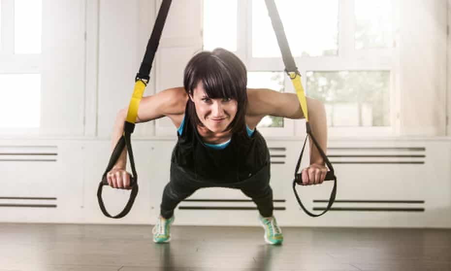 A woman doing suspension training