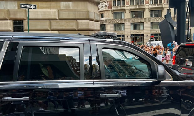 Trump declines to answer questions in New York business investigation | Donald Trump 1 black suv on NY street with trump just visible in back seat