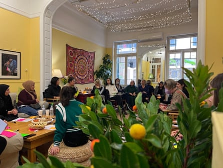 A large group of women sitting in a big room