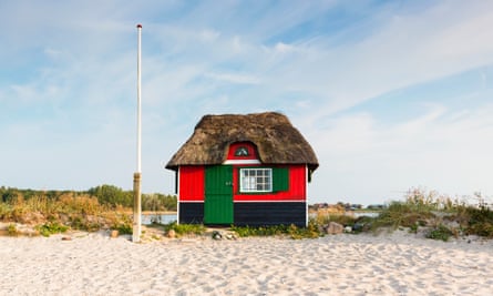 Thatched-roof beach hut at a grass covered sand dune by the Baltic Sea, Aero Island, Denmark.