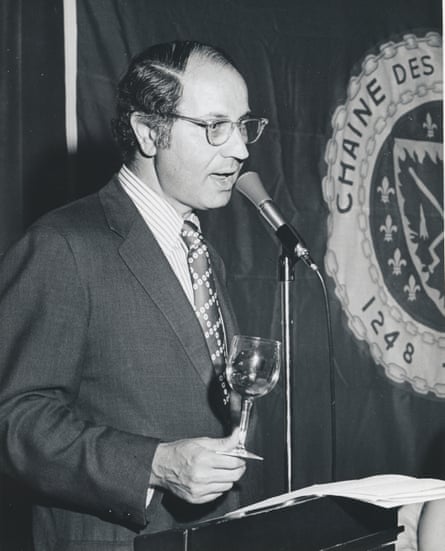 Sichel, holding a glass of wine, speaks through a microphone