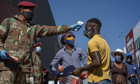 South African National Defense Forces check people’s temperature in Johannesburg’s Alexandra township on 20 May 2020.