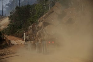 A truck carries logs amid forest fires along the road to Jacunda National Forest near the city of Porto Velho in the Vila Nova Samuel region which is part of Brazil’s Amazon, Monday, Aug. 26, 2019.
